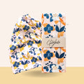 Floral headband and packaging with 'GoldieBocks' branding on a beige background