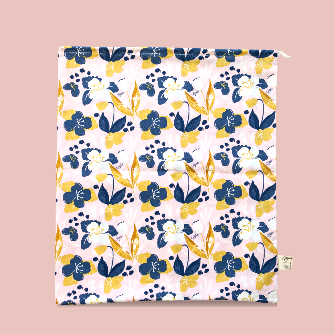 Floral patterned fabric with blue and yellow flowers on a pink background