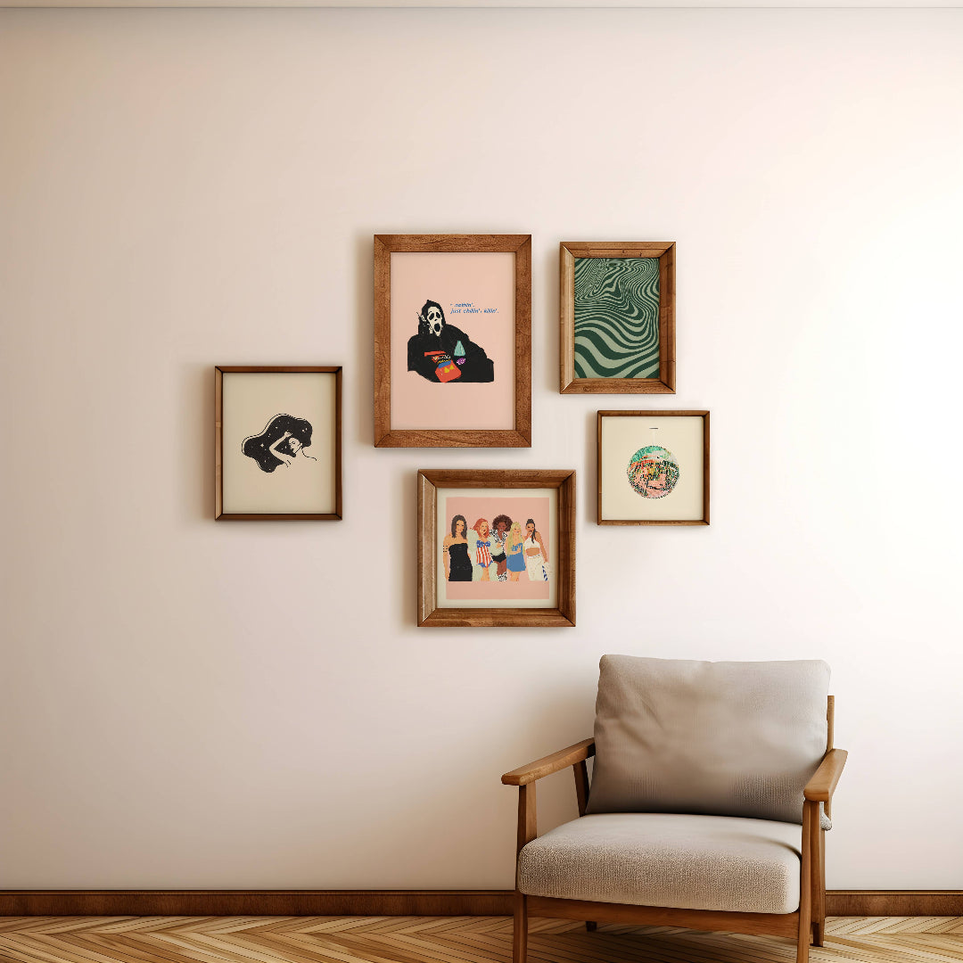 Framed artworks on a wall with a chair in front