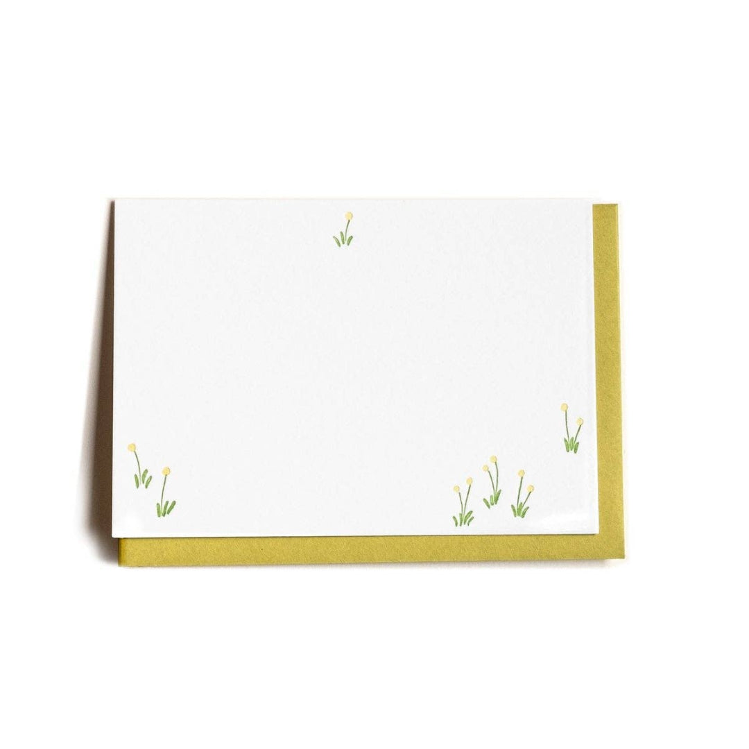 White card with green grass illustrations on a white background