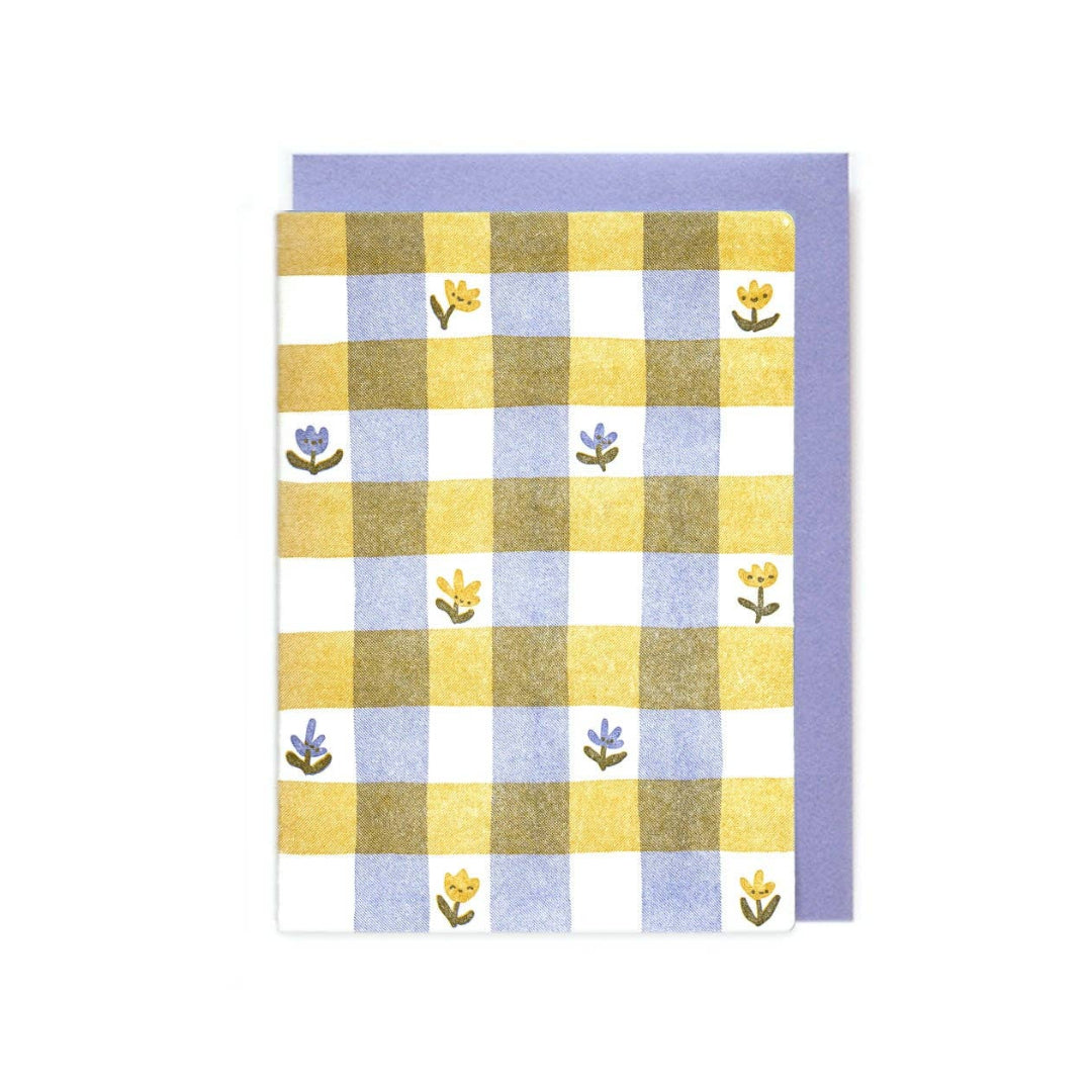 Checkered towel with floral patterns on a white background