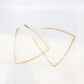 Gold triangle-shaped earrings on a white background