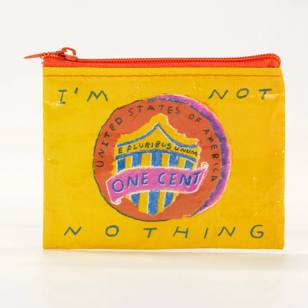 A yellow coin purse with a playful design. The purse features a modified version of the "One Cent" coin design, with the words "I'M NOT NOTHING" replacing "UNITED STATES OF AMERICA." The purse has a bright orange zipper.