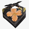A black bandana with a floral pattern. The pattern features orange flowers and green leaves on a black background.