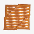 Orange and white patterned fabric on a white background