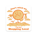 Cartoon sun with arms and legs on clouds, text 'Don't mind me, I'm just shopping local' on a white background