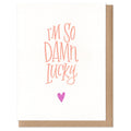 Card with 'I'm so damn lucky' text and a heart on a white background