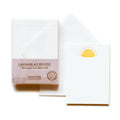 Packaging of notecards with envelopes and a single notecard on a white background