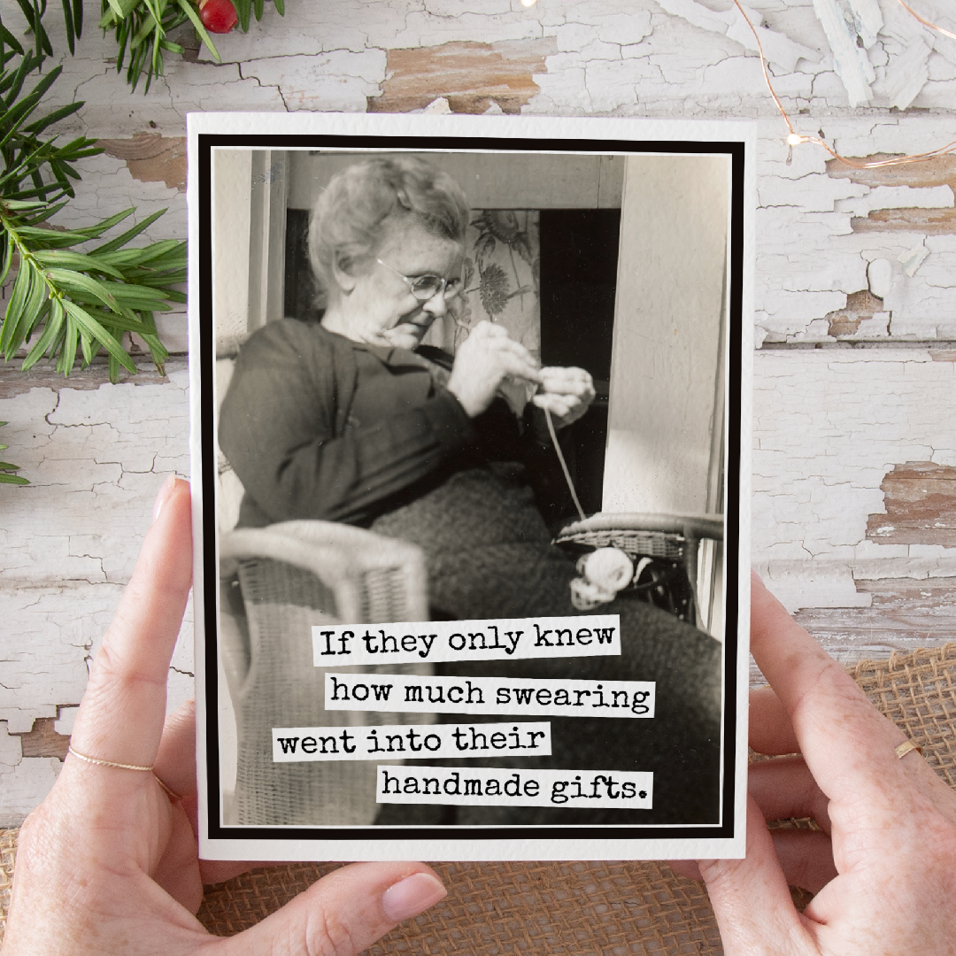 Person holding a card with a black and white photo of an elderly woman knitting and humorous text.