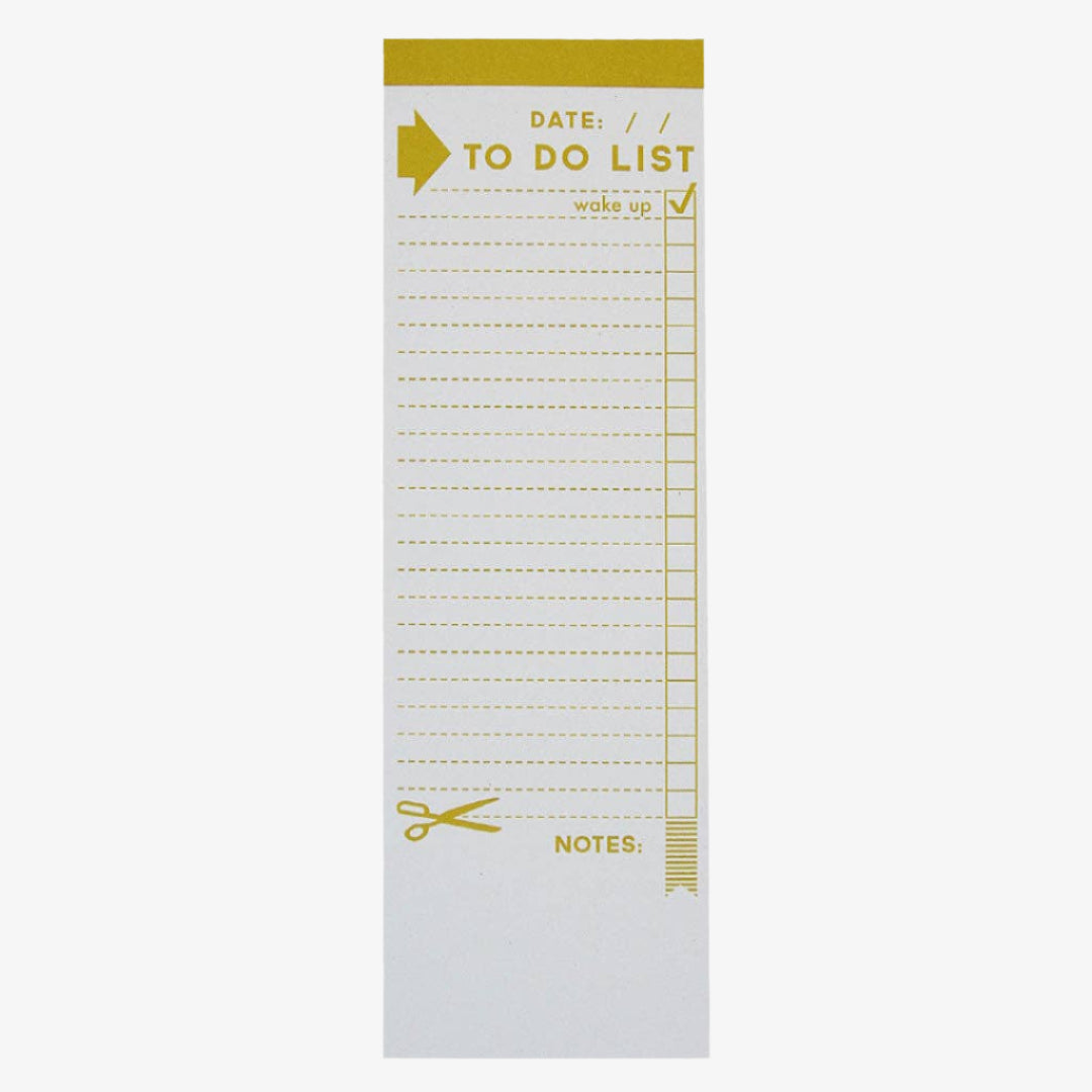 A tall, yellow and white notepad with a "TO DO LIST" heading and checkboxes next to blank lines. The top right has a checked box next to "wake up". Scissors are printed near the bottom, indicating a tear-off section for notes.