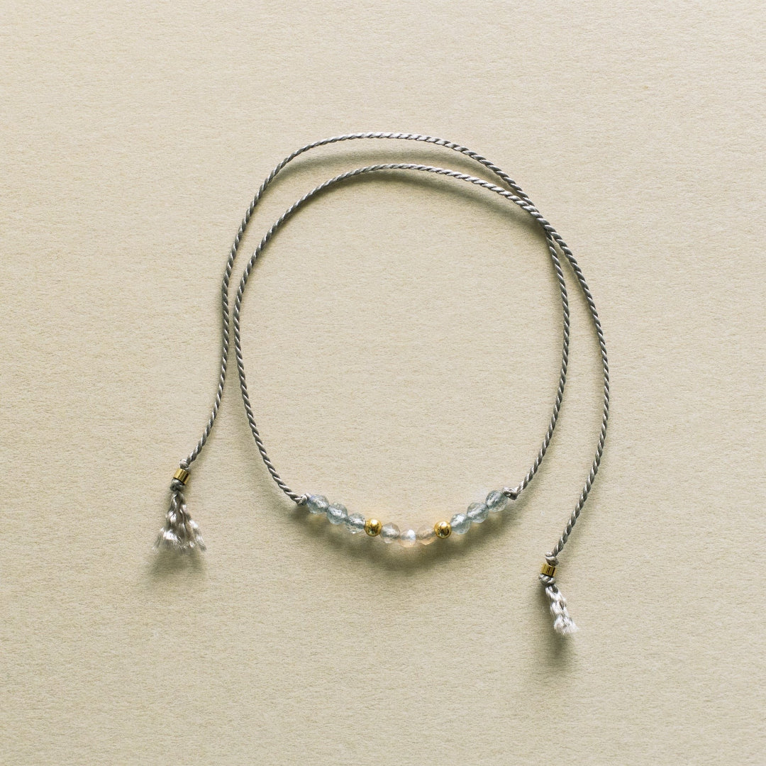 Necklace with beaded chain on a beige background