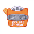 Embroidered patch of a car with 'EXPLORE AT HOME' text on an orange background