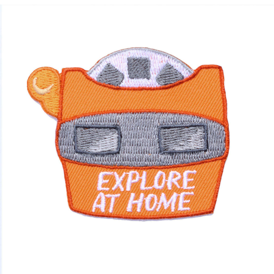 Embroidered patch of a car with 'EXPLORE AT HOME' text on an orange background